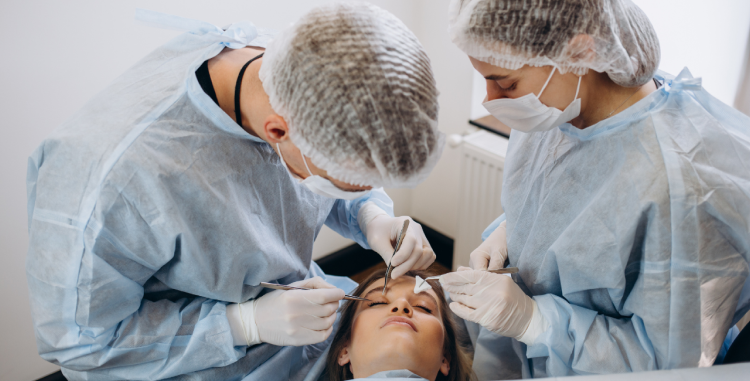 A woman undergoing thyroid eye surgery, assisted by two medical professionals during the procedure